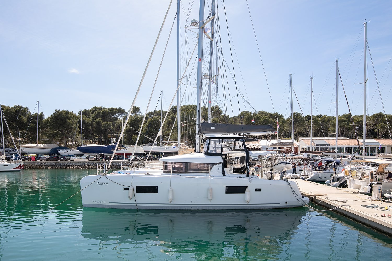 Lagoon 42 catamaran Mare Fiero moored stern-to at ACI Marina Pomer near Pula, name visible on the port hull
