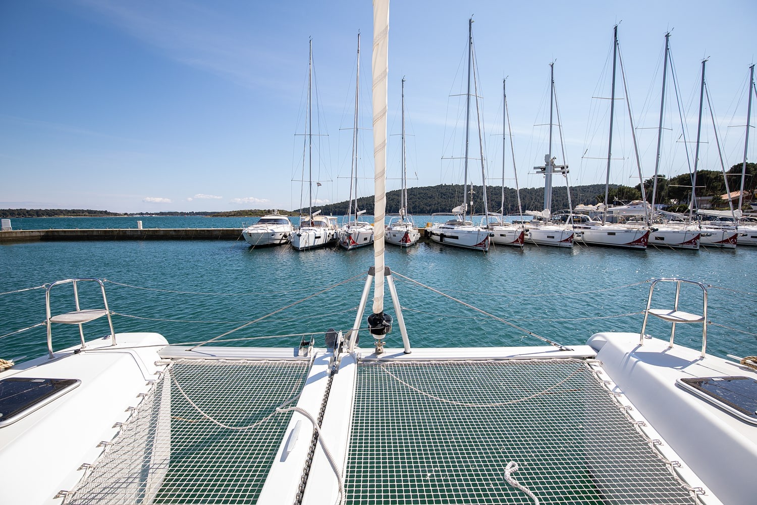 View from the trampolines of the Lagoon 42 across the moored yachts of ACI Marina Pomer