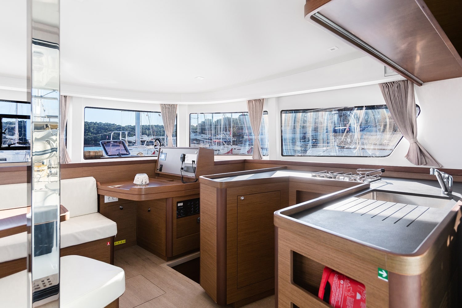 Galley and navigation station of the Lagoon 42 with gas hob, sink and instrument panel