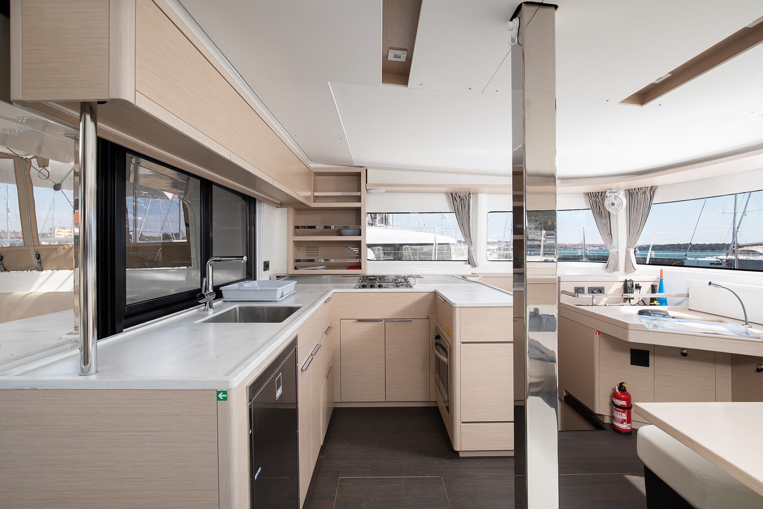 U-shaped galley of the Lagoon 46 with double sink, gas hob, oven, fridge and generous worktop under an opening window