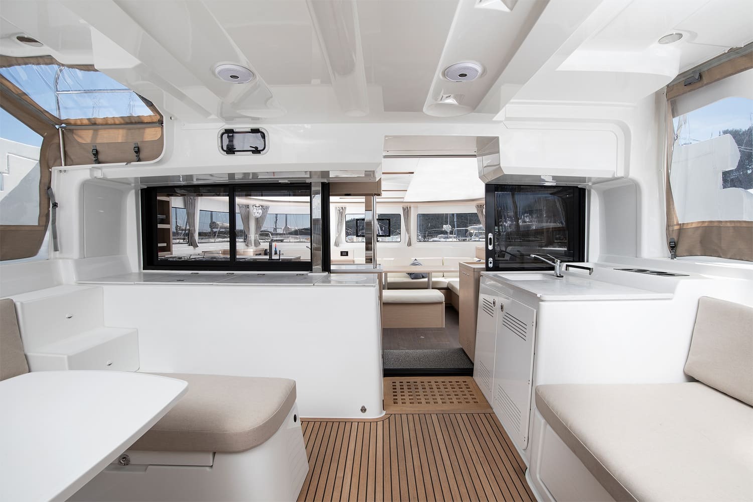 Cockpit of the Lagoon 46 with teak sole, wet bar and sink, bench seating and sliding doors opening into the saloon
