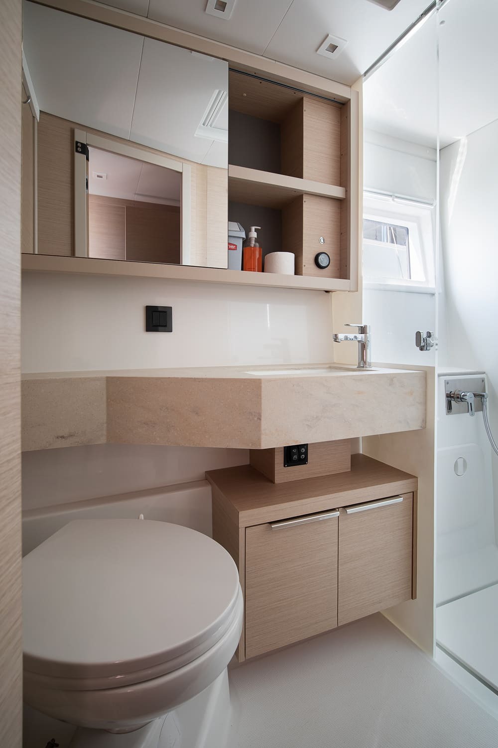 En-suite heads on the Lagoon 46 with electric toilet, stone washbasin, mirrored cabinet and separate shower cubicle
