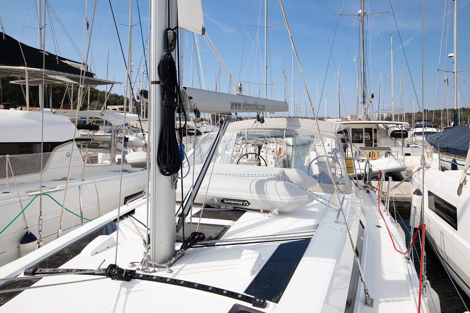 Foredeck with the dinghy stowed ahead of the mast and the mainsail flaked in its bag