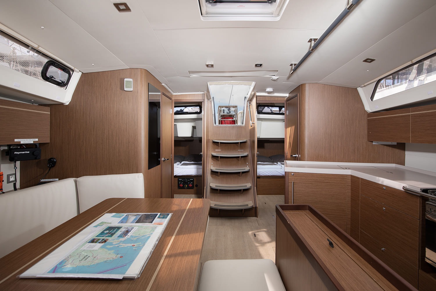 Saloon looking aft to the companionway steps, with a cabin either side