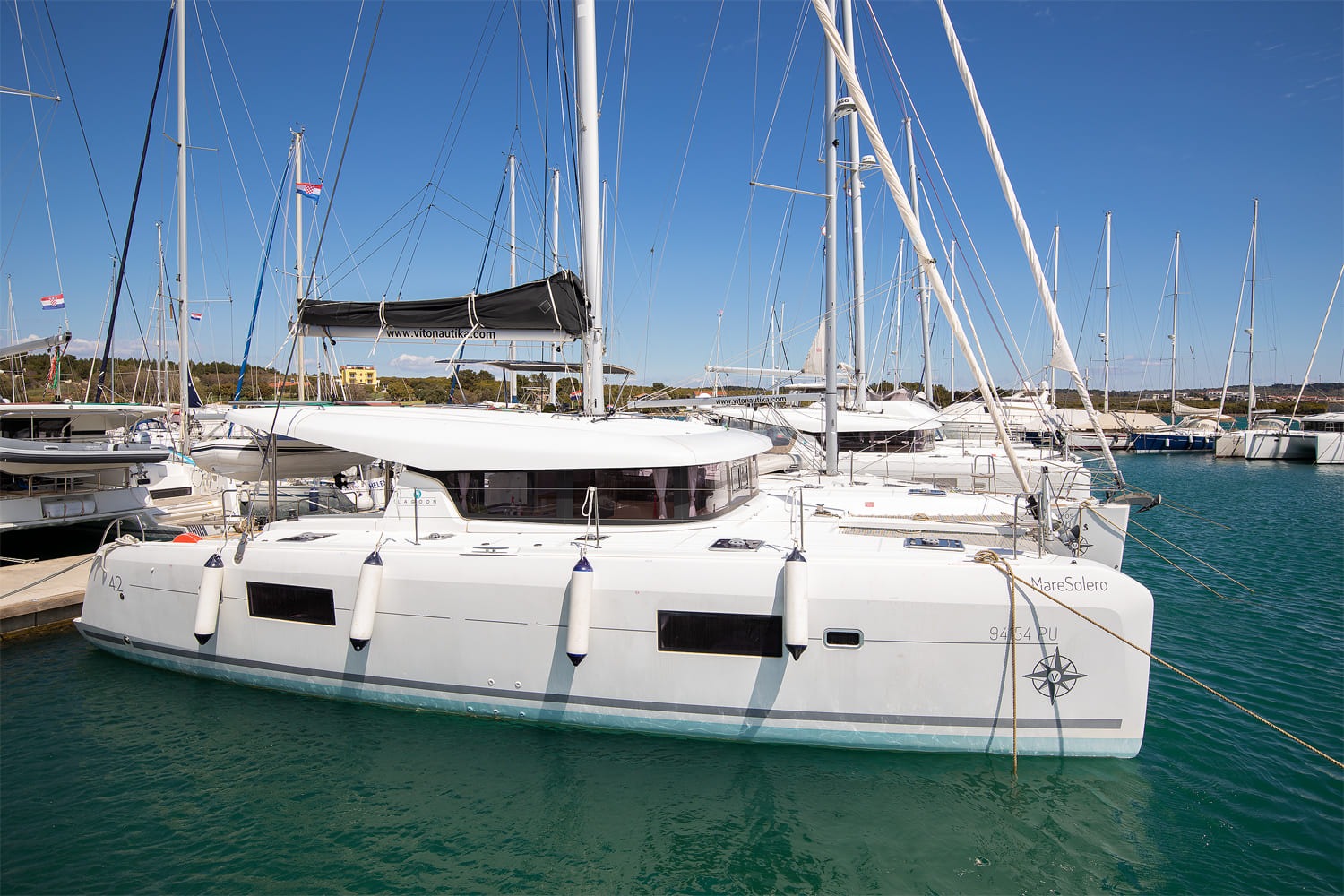 Mare Solero, a Lagoon 42 catamaran, lying alongside at ACI Marina Pomer near Pula, seen from the pontoon.