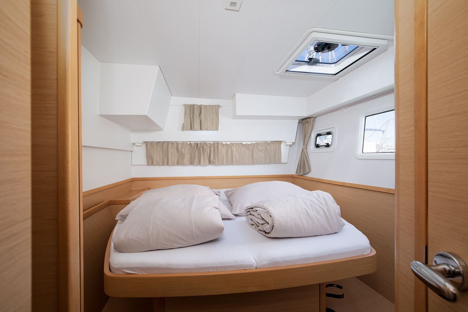 Double cabin in one hull, with an overhead hatch, opening portlight and shelved oak joinery.