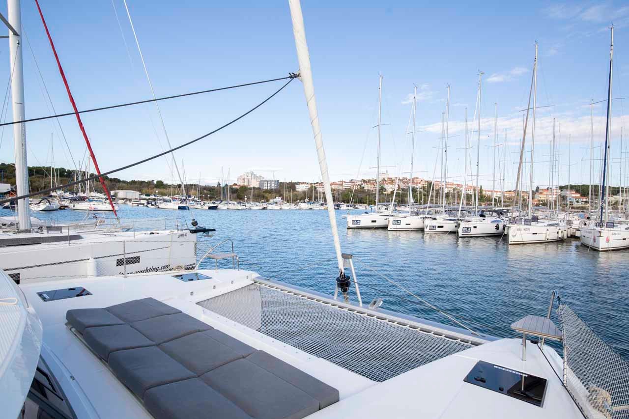 The foredeck trampoline of Follow the Sun looking out across the marina towards the town beyond.