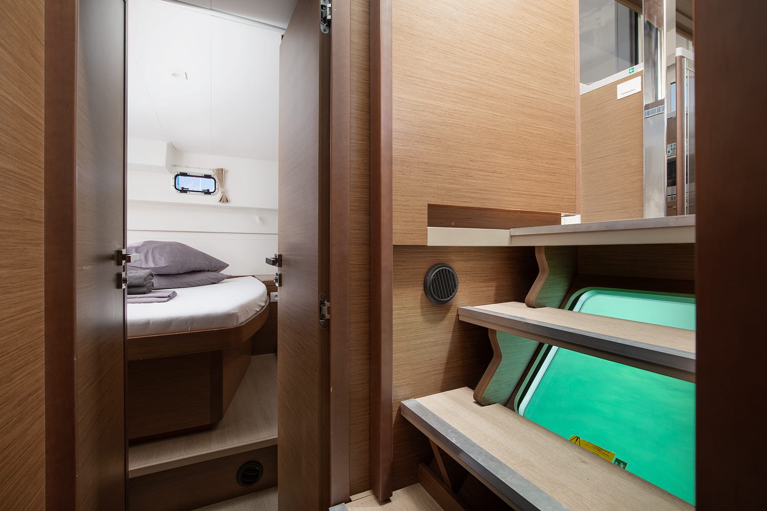 Companionway steps down into the hull, with an open door to a double cabin alongside