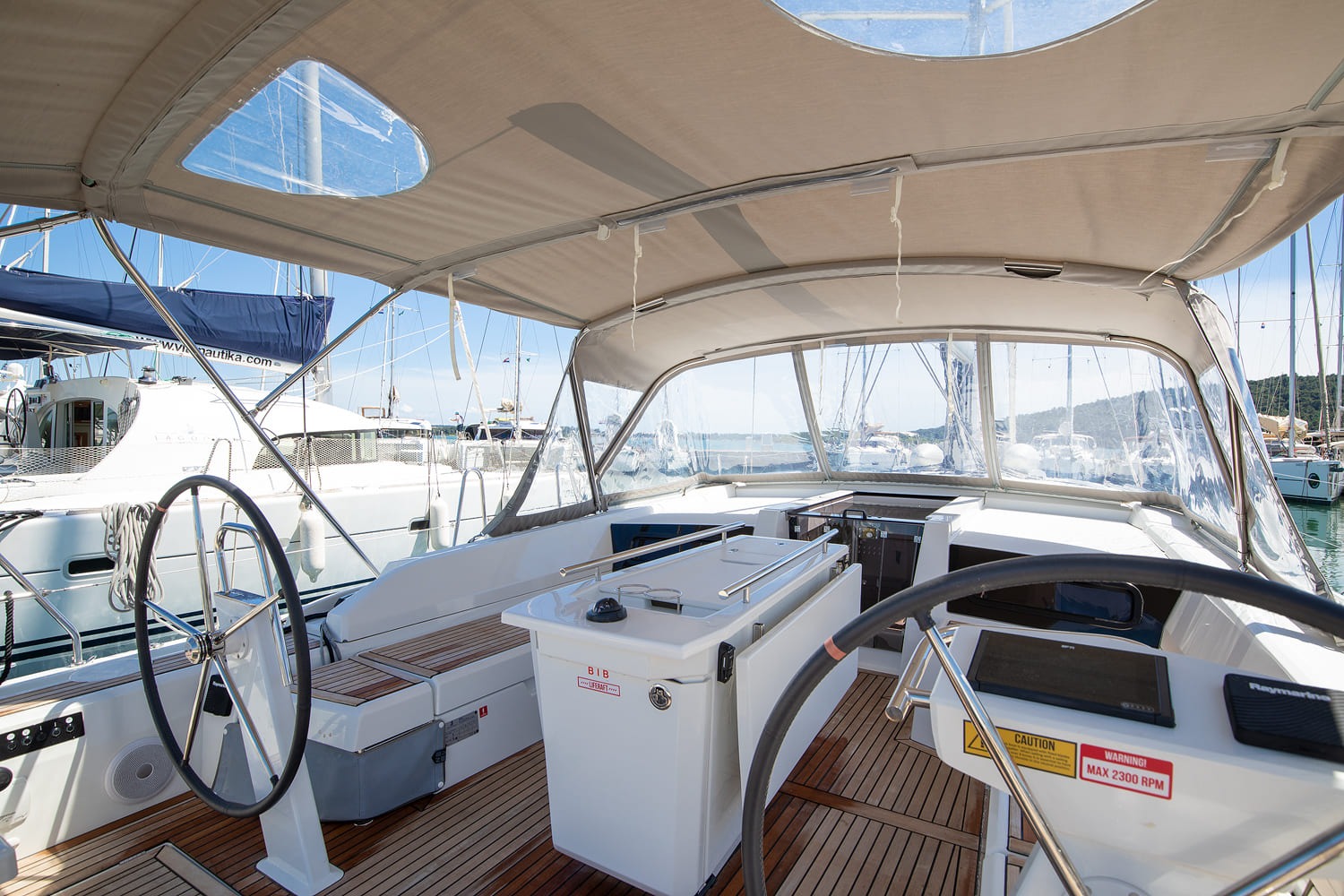 Cockpit of the Beneteau Oceanis 46.1 under the bimini, twin helms and folding table