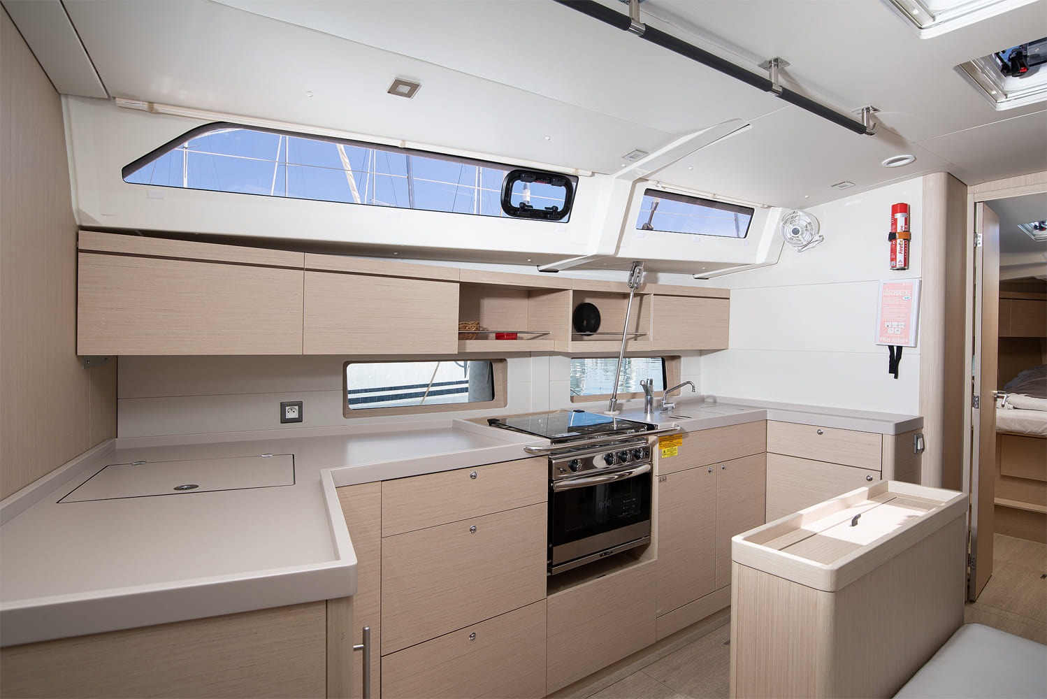 Galley with worktop and stowage, hull windows above