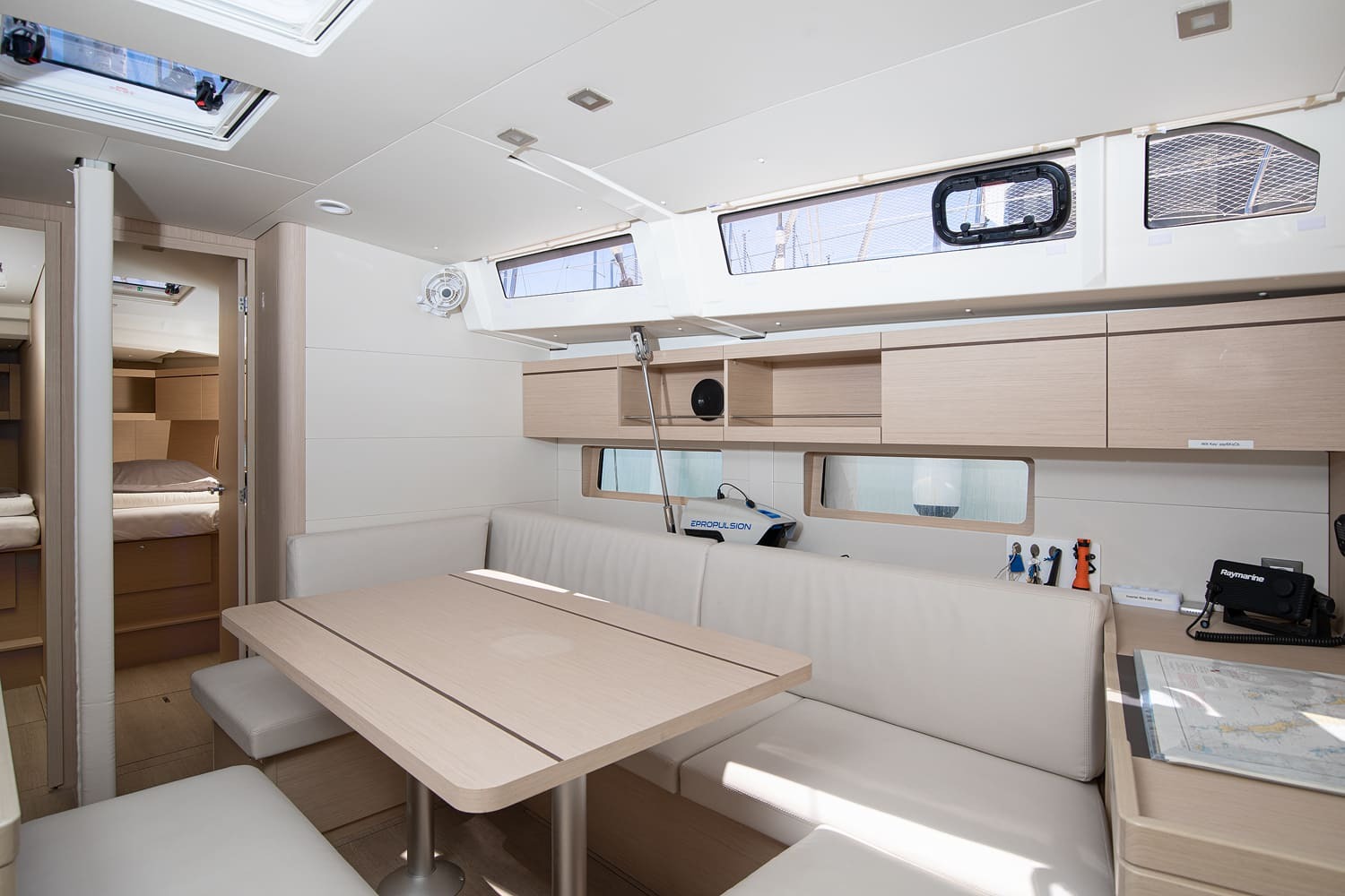 Saloon seating and dining table beneath the coachroof windows