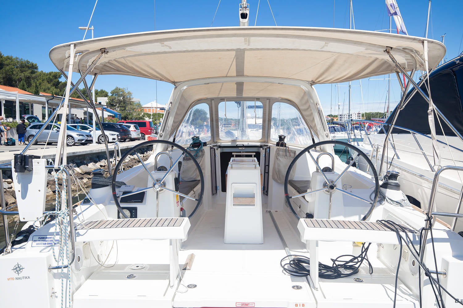 Beneteau Oceanis 35 in her berth at ACI Marina Pomer, bimini rigged over the cockpit