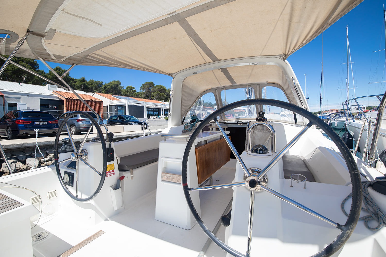 Helm station with wheel, instruments and folding cockpit table