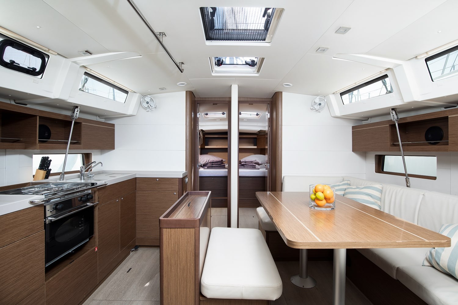 Galley of the Vento di Mare with worktop, sink and stowage, seen from the saloon.
