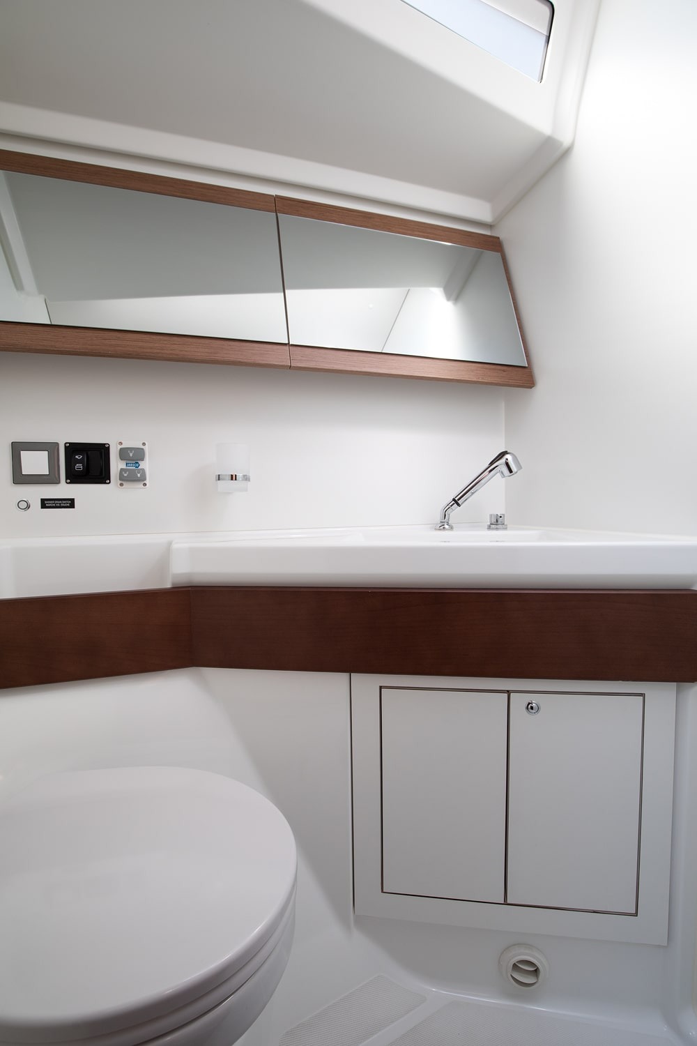 Heads compartment aboard the Vento di Mare with washbasin and shower.