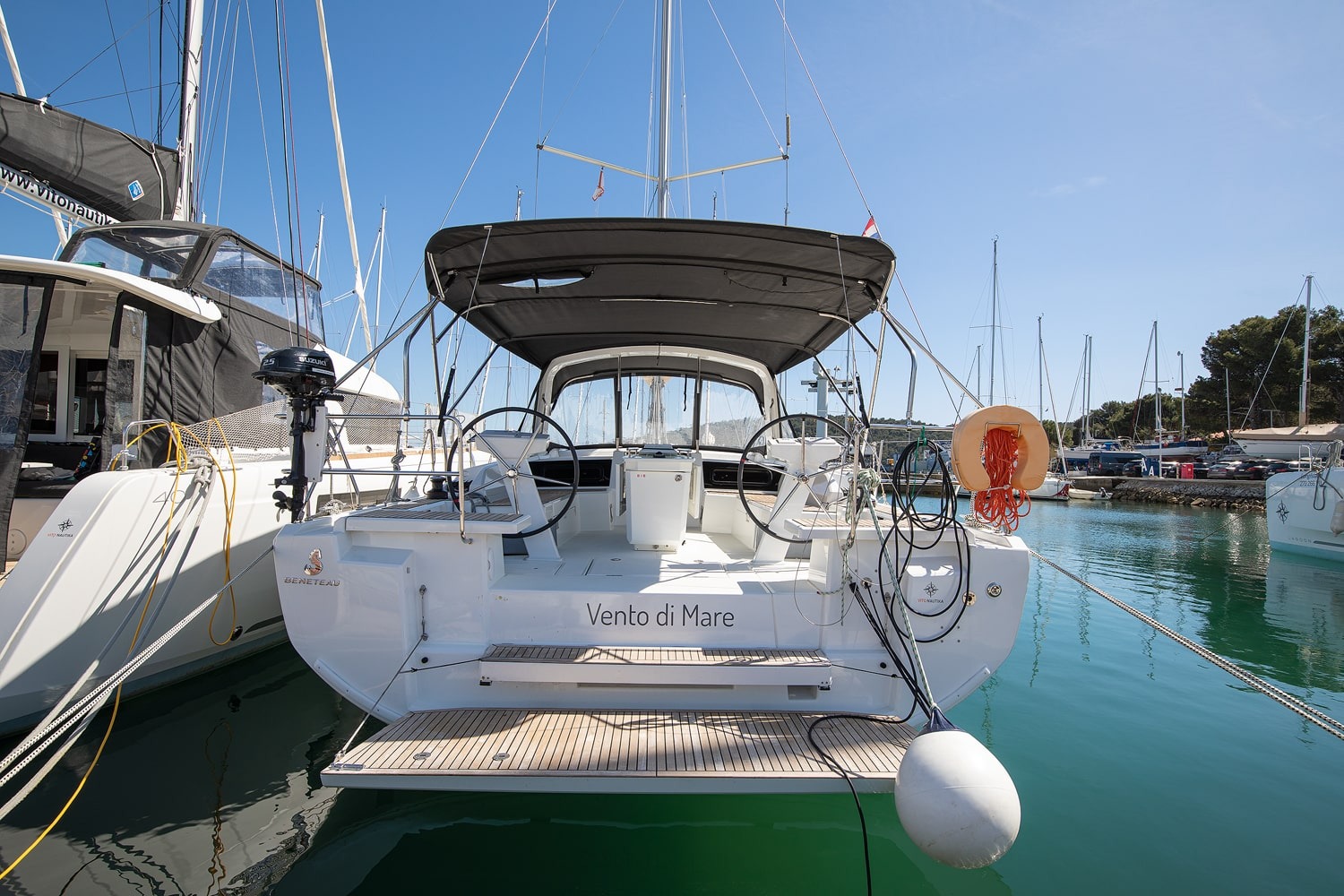 Stern of the Vento di Mare with the bimini-covered cockpit and bathing platform.