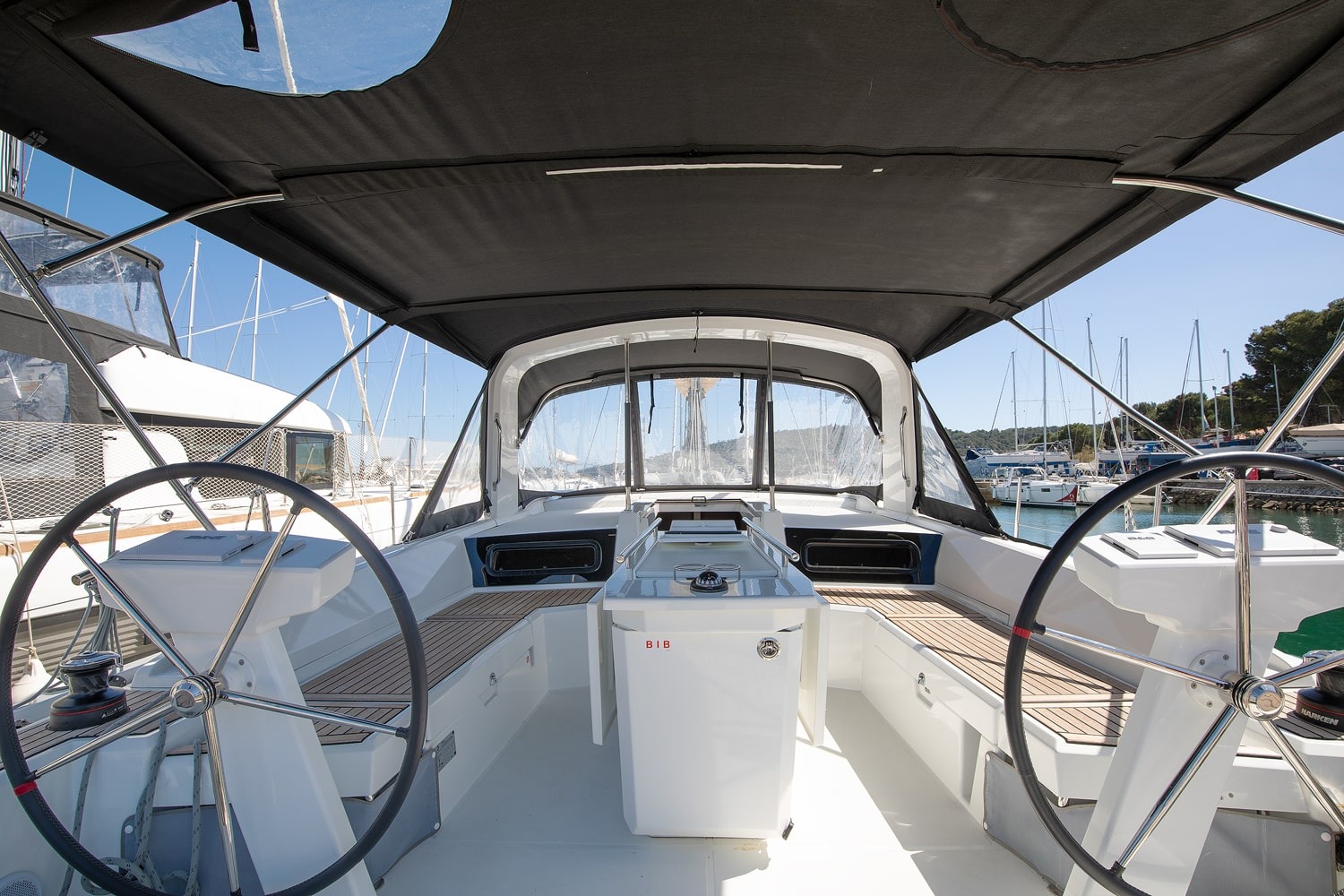 Twin wheels and the open cockpit of the Vento di Mare, looking aft towards the bathing platform.