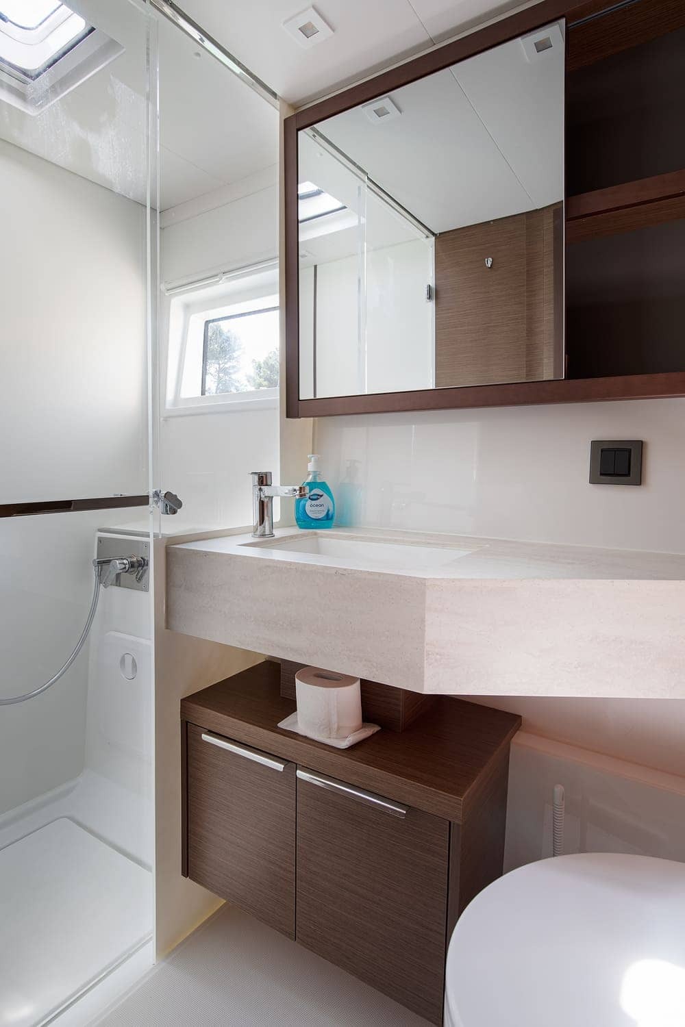 Heads aboard the Lagoon 46 Venice Beach, with separate shower stall, stone-topped basin and mirrored cabinet