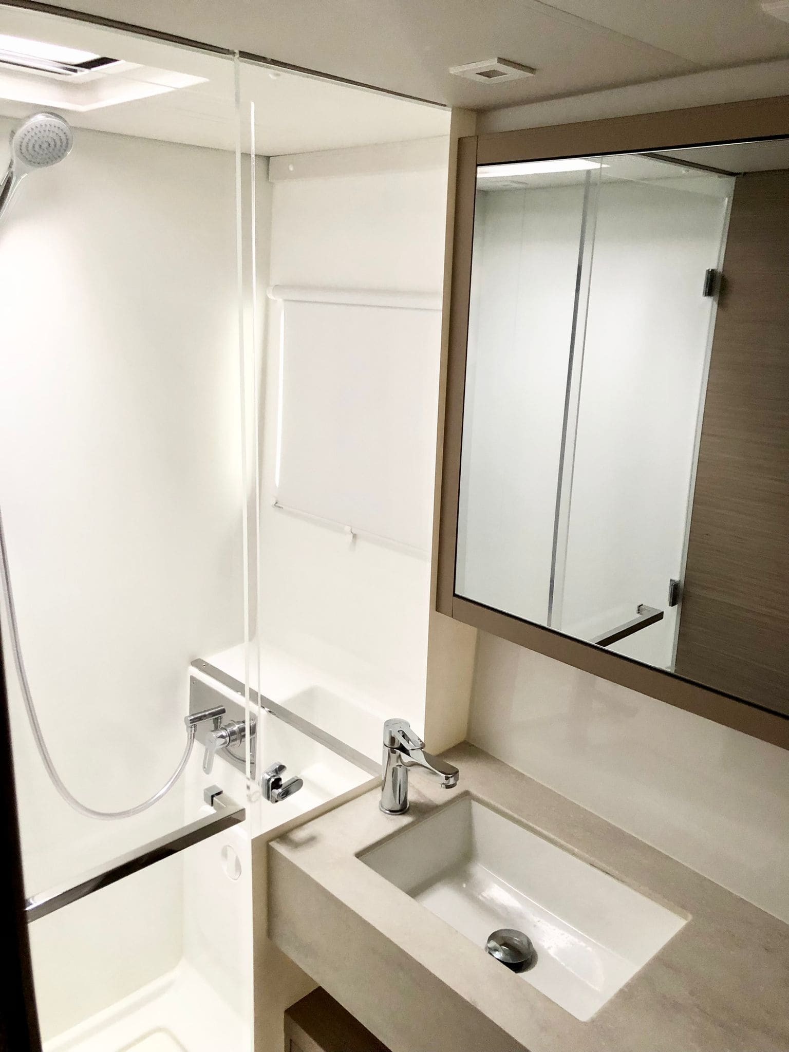 Second heads aboard the Lagoon 46 Venice Beach, with glass-screened shower, moulded basin and full-height mirror