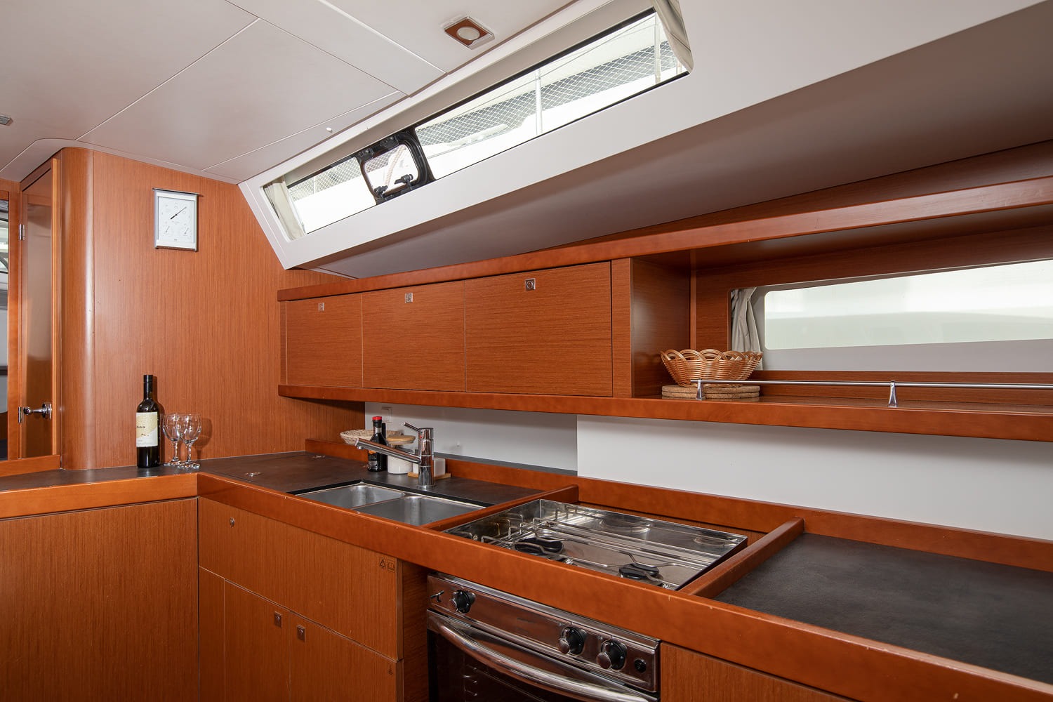 Galley of the Oceanis 45, with twin sink, gas oven, hob and overhead storage lockers