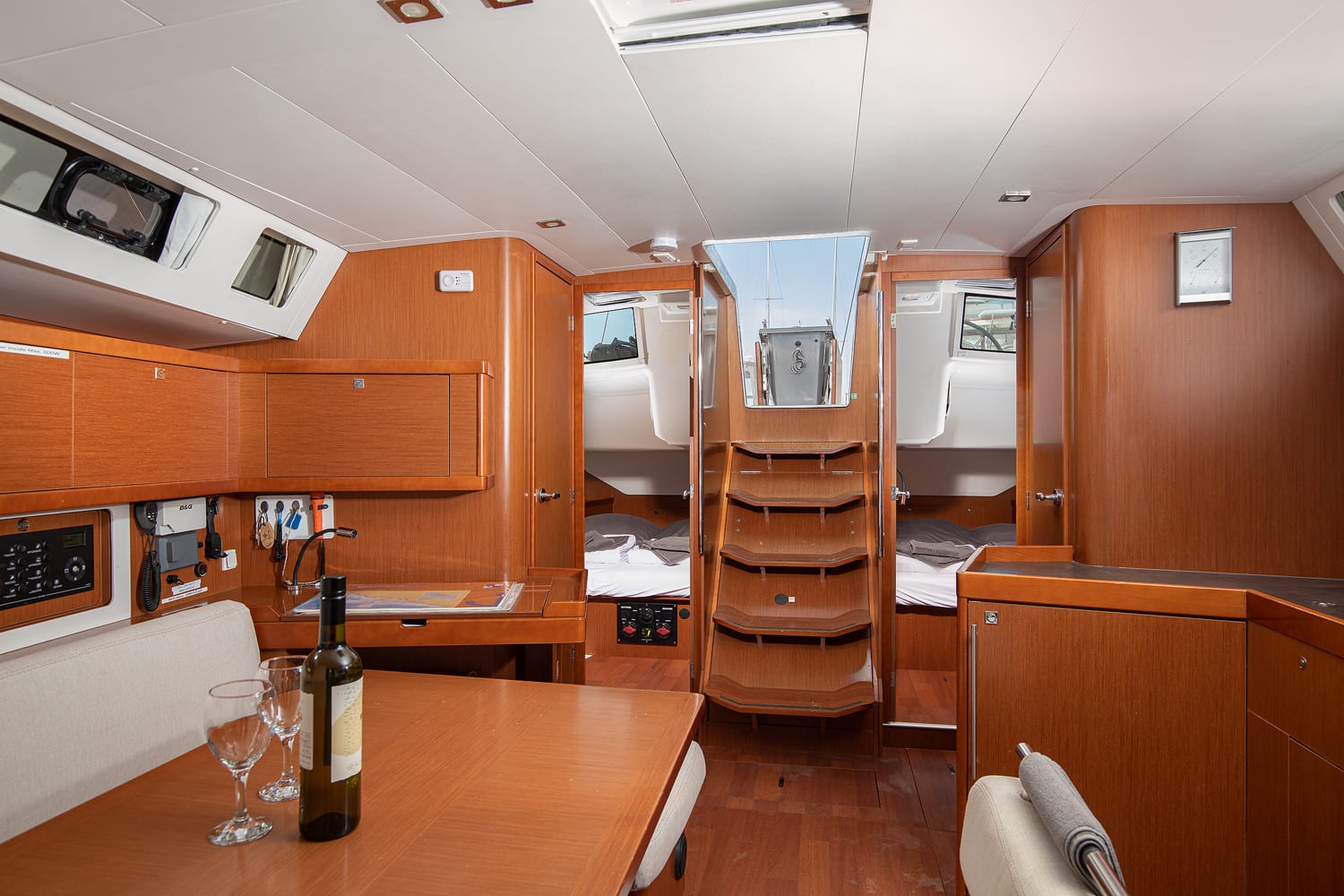 Saloon of Mare Aeolos looking aft, with companionway steps between the two aft cabins and the chart table to port